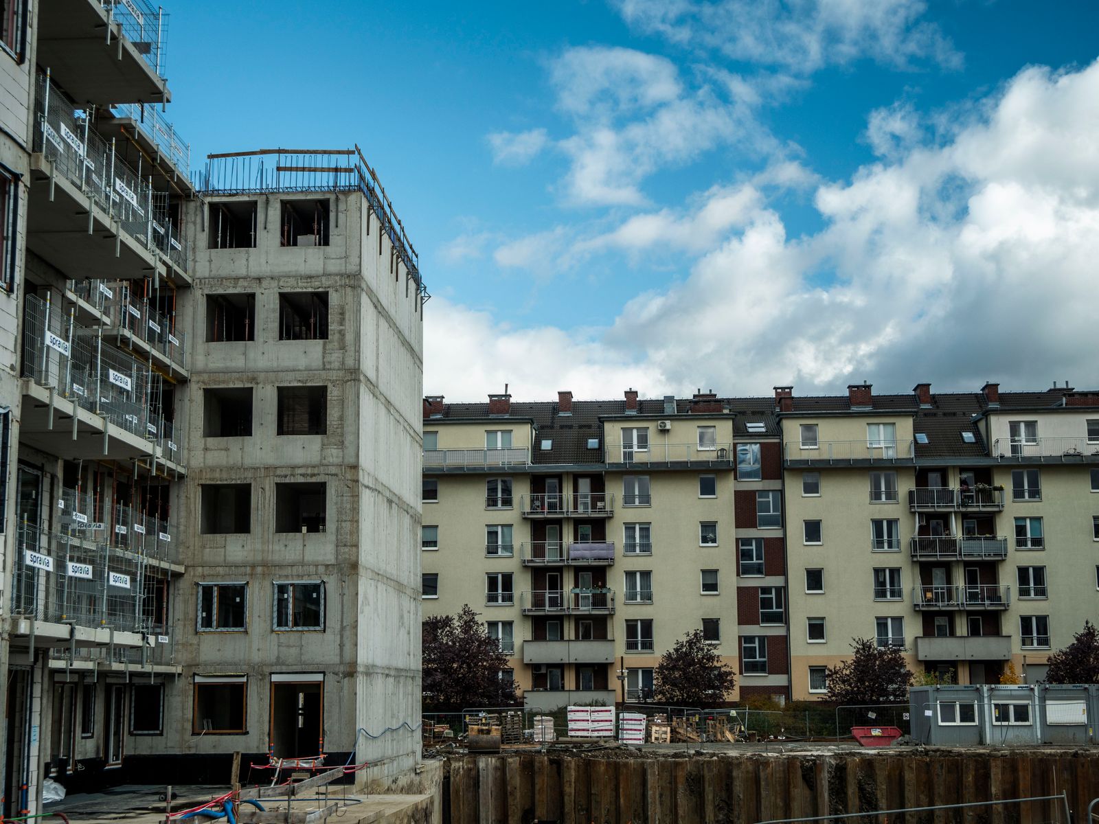 Apartment blocks under construction beside a finished development