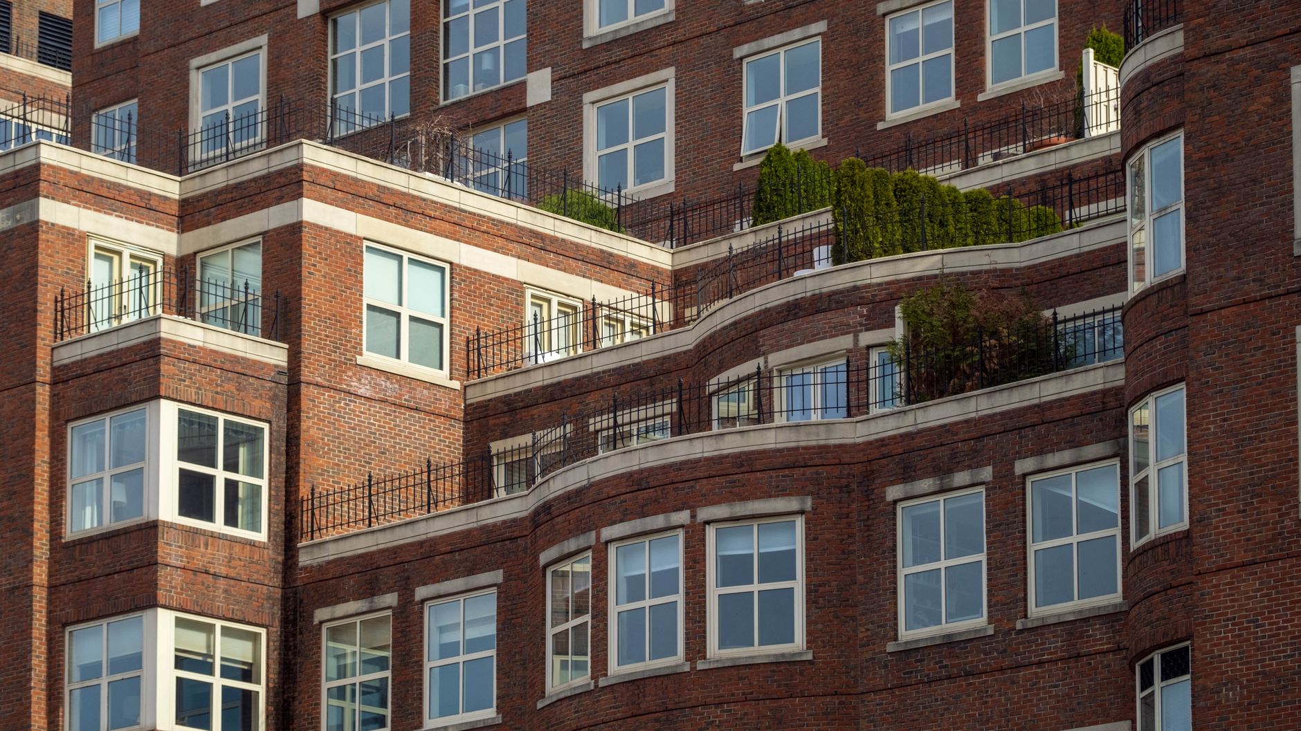 A red brick apartment block with terraces