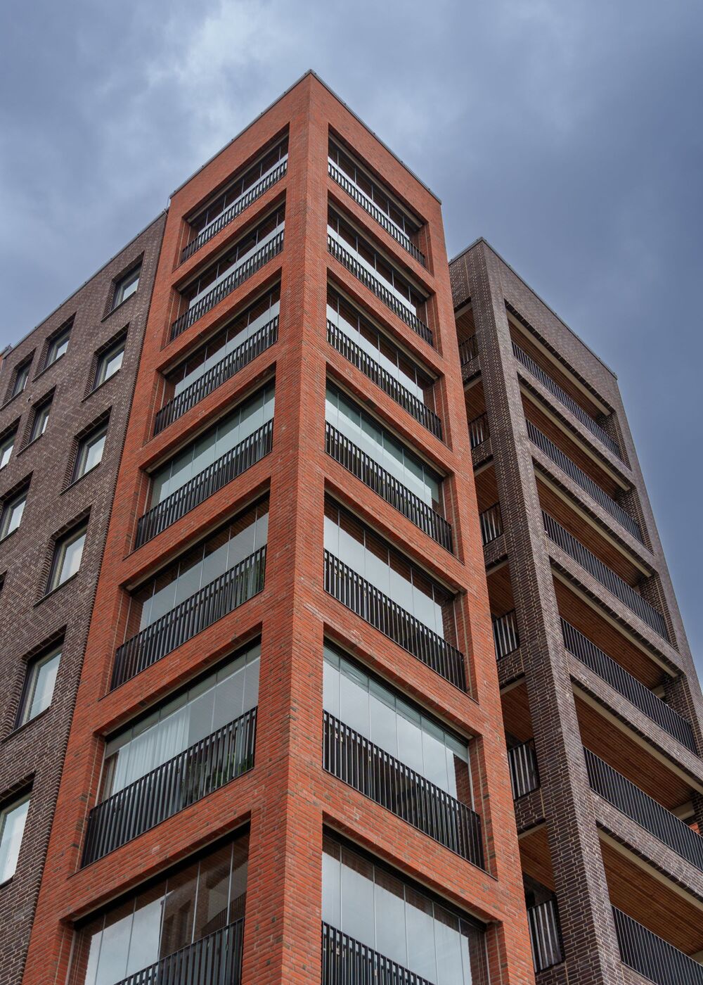 A modern brick apartment building with balconies