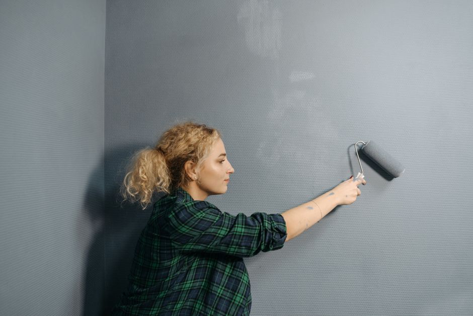 Decorator rolling paint onto a wall