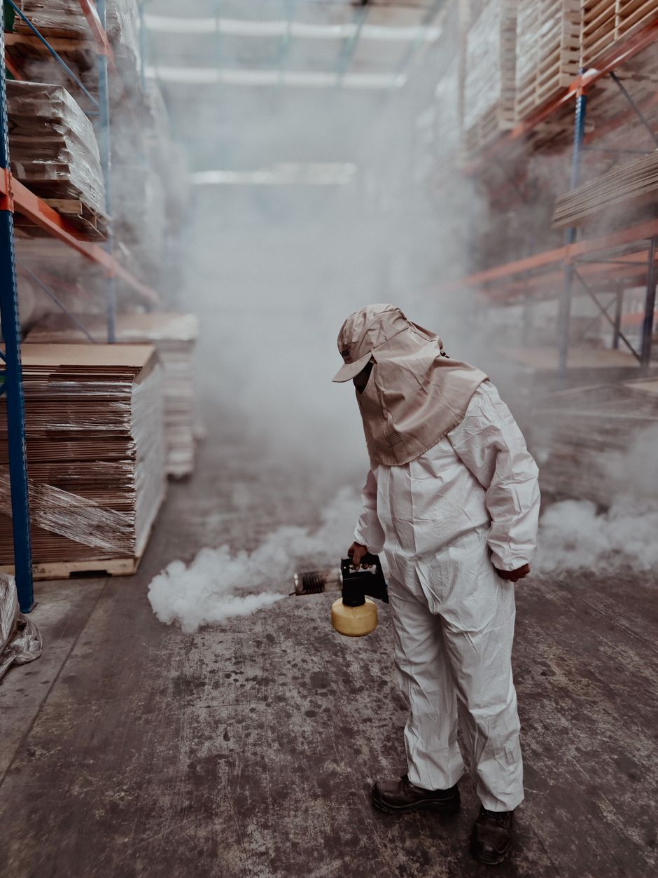 Pest control technician treating a warehouse