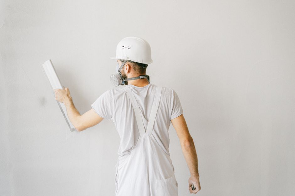 Plasterer finishing a wall